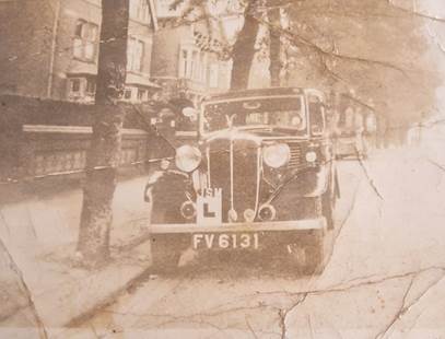 An old photo of a car on the street in 1937, used by a learner driver
